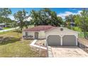 Inviting single-story home with a 2-car garage and a chain-link fence for added privacy and security at 70 Sapphire Rd, Ocala, FL 34472