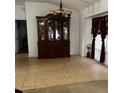 Dining room boasting tile floors, chandelier, and elegant china cabinet at 7802 Sw 114Th Loop, Ocala, FL 34476
