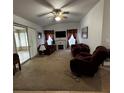 Inviting living room featuring plush seating, fireplace, and large sliding glass doors at 7802 Sw 114Th Loop, Ocala, FL 34476