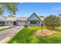 Charming single-story home featuring a well-manicured lawn, and an attached one-car garage at 8431 Sw 93Rd Pl # F, Ocala, FL 34481