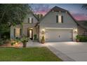 Charming home exterior boasts a two-car garage, stone accents, and a manicured green lawn at 9158 Sw 65Th Loop, Ocala, FL 34481