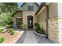 Inviting front porch with stone accents, comfortable seating, and lush landscaping at 9158 Sw 65Th Loop, Ocala, FL 34481