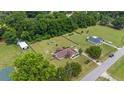 Wide aerial shot of the home, showcasing the surrounding neighborhood, yard and outbuildings at 9420 Ne 12Th Ct, Ocala, FL 34479