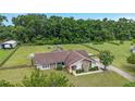 Expansive aerial view of a single Gathering home, barn and yard surrounded by mature trees at 9420 Ne 12Th Ct, Ocala, FL 34479
