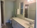 Bright bathroom with a large mirror and well-lit vanity, complemented by a neutral color scheme at 9722 Sw 95Th Ct # C, Ocala, FL 34481