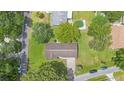 Overhead view of the home with a well-manicured lawn, mature trees, and proximity to neighborhood pool at 12178 Palmetto Way, Dunnellon, FL 34432