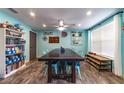 Light-filled dining room featuring tile floors, a large wooden table, and whimsical decorative accents at 1404 Richmond Rd, Lakeland, FL 33801