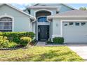 Inviting front entrance with lush landscaping and a well-maintained lawn at 1584 Silhouette Dr, Clermont, FL 34711