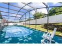 Relaxing screened-in pool area with white furniture for lounging and entertaining at 1584 Silhouette Dr, Clermont, FL 34711