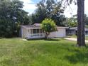 Inviting single-story home featuring a front porch and a one-car garage at 2426 Maple Ave, Sanford, FL 32771