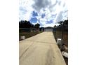 Gated driveway leading to a well-maintained home with ample parking space at 2550 Sw Ivy Pl, Dunnellon, FL 34431