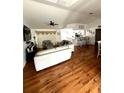 Open-concept living room with hardwood floors and abundant natural light at 2550 Sw Ivy Pl, Dunnellon, FL 34431