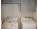 Convenient laundry area with washer, dryer, and overhead cabinets for storage at 3223 Sw 41St Ave, Ocala, FL 34474