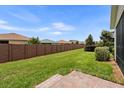 Spacious backyard with lush green grass and a privacy fence at 4232 Nw 56Th Ct, Ocala, FL 34482