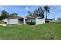 Lovely home featuring a lush green lawn and well-maintained exterior with blue sky at 5320 Sw 128Th Pl, Ocala, FL 34473