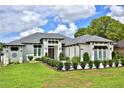 Beautiful home with manicured lawn and lush greenery enhancing curb appeal at 5845 Sw 43Rd Street Rd, Ocala, FL 34474