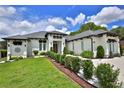 Attractive home with well-maintained landscaping, a beautiful lawn, and elegant architectural details at 5845 Sw 43Rd Street Rd, Ocala, FL 34474