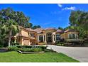 Charming residence showcasing a circular driveway, a basketball hoop, and colorful garden beds at 695 Se 47Th Loop, Ocala, FL 34480