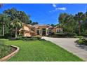 Lovely home with lush green lawn, mature landscaping, and a circular driveway leading to the residence at 695 Se 47Th Loop, Ocala, FL 34480