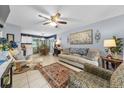 Inviting living room with a ceiling fan, tile flooring, and comfortable seating that create a cozy ambiance at 7961 Midway Drive Ter # J102, Ocala, FL 34472