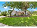 Inviting single-story home with a well-manicured lawn and mature trees at 8034 Sw 81St Loop, Ocala, FL 34476