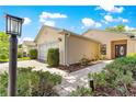 Single-story home featuring manicured landscaping and a brick walkway to the front door at 8034 Sw 81St Loop, Ocala, FL 34476