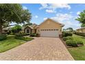 Attractive home with a brick driveway, two-car garage, and manicured landscaping at 8611 Sw 83Rd Loop, Ocala, FL 34481