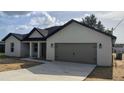 Attractive single-story home showcasing modern design with a gray two-car garage at 9721 Bahia Rd, Ocala, FL 34472