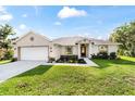 Charming single-story home with a well-manicured lawn and inviting curb appeal during daylight at 9957 Sw 45Th Ave, Ocala, FL 34476