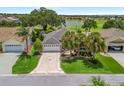 Aerial view of home showcasing well-maintained landscaping, a golf course view, and mature trees at 1266 James Island St, The Villages, FL 32162