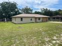 Single story home with an attached single car garage, and a fenced in yard at 145 Ne 71St Ave, Ocala, FL 34470