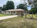 Single story home with an attached single car garage, and a fenced in yard at 145 Ne 71St Ave, Ocala, FL 34470