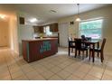 Eat in kitchen featuring an island, tile flooring, and a view to the backyard at 145 Ne 71St Ave, Ocala, FL 34470