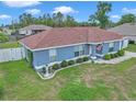 Charming single-story home with a well-maintained lawn and inviting curb appeal, featuring white-framed windows and nice shrubbery at 14762 Sw 22Nd Court Rd, Ocala, FL 34473