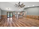 Open-concept living area featuring wood-look floors, wood trim and a view of the patio and pool at 15360 Se 73Rd Avenue, Summerfield, FL 34491