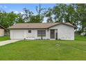 Charming single-story home features a welcoming facade, attached garage and a well-manicured lawn at 21191 Sw Plantation St, Dunnellon, FL 34431