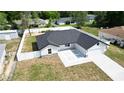 Aerial view of the new home, showcasing the well-manicured lawn and privacy fence at 28 Hemlock Circle Pass, Ocala, FL 34472