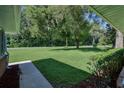 Expansive front yard with lush green grass, mature trees, and tidy landscaping offering curb appeal at 2855 Se 38Th St, Ocala, FL 34480
