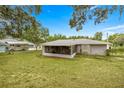 Backyard featuring a screened patio, creating an ideal space for outdoor relaxation and entertainment at 329 Larch Rd, Ocala, FL 34480