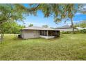 Rear exterior view with a screened-in porch offering a private outdoor living area at 329 Larch Rd, Ocala, FL 34480