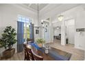 Bright dining room with large window, elegant chandelier, and views to the entry at 3993 Se 10Th Ave, Ocala, FL 34480