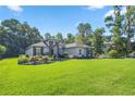 Expansive lawn and meticulously maintained landscaping highlight the home's facade at 3993 Se 10Th Ave, Ocala, FL 34480