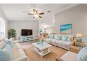 Comfortable living room features neutral paint, ceiling fan, cozy furniture, with view into dining area at 4 Dogwood Run, Ocala, FL 34472