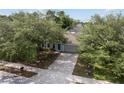 An aerial view of a well maintained single story house with a large driveway and a luscious lawn at 4531 Se 27Th St, Ocala, FL 34480