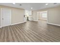 Open-concept living room showcasing sleek floors and access to the modern kitchen at 5 Bahia Circle Pl, Ocala, FL 34472