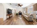 Well-lit living room showcasing hardwood floors, fireplace, and neutral-toned furniture at 6495 Sw 109Th St, Ocala, FL 34476
