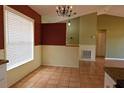 Bright dining area features a large window with a view, chandelier, and neutral decor, adjacent to the kitchen at 7 Pecan Drive Loop, Ocala, FL 34472