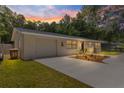 Charming single-story home with a well-manicured lawn and a concrete driveway leading to an attached garage at 802 Ne 39Th Ct, Ocala, FL 34470
