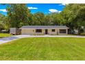 Well-kept single-story home with lush green lawn and a long driveway at 802 Ne 39Th Ct, Ocala, FL 34470