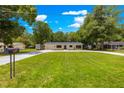 Well-kept single-story home with lush green lawn and a long driveway at 802 Ne 39Th Ct, Ocala, FL 34470